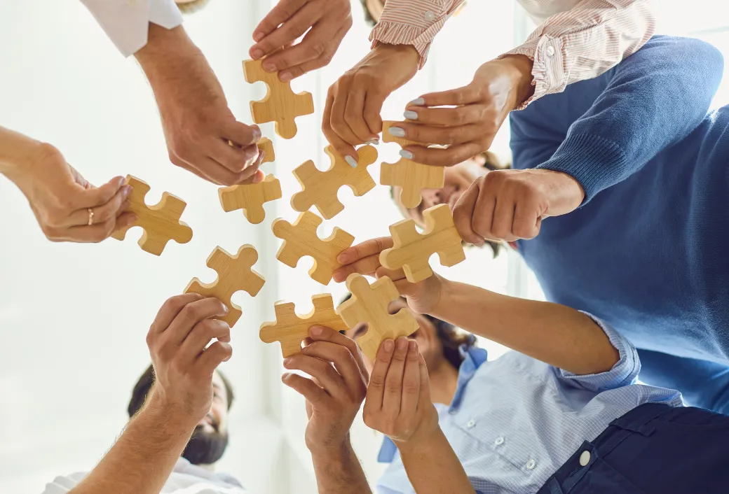 team holding puzzle piece